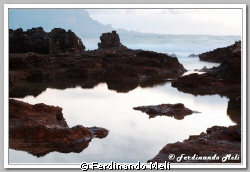 A mirror effect of the beach rocks. by Ferdinando Meli 